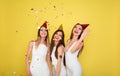 Party and holidays concept. Three glamour women in luxury glitter sequins dress dancing and having fun with confetti and