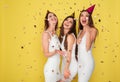 Party and holidays concept. Three glamour women in luxury glitter sequins dress dancing and having fun with confetti and