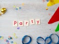 Party Lettering with party decoration on wooden background