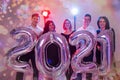 Party, people and new year holidays concept - women and men celebrating new years eve 2021