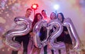 Party, people and new year holidays concept - women and men celebrating new years eve 2021