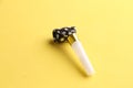 Party noisemaker isolated on a yellow background