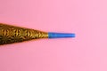 Party noisemaker on a pink background