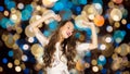 Happy young woman dancing over party lights Royalty Free Stock Photo