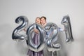 Party, people and new year holidays concept - woman and man celebrating new years eve 2021 Royalty Free Stock Photo