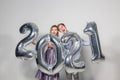 Party, people and new year holidays concept - woman and man celebrating new years eve 2021 Royalty Free Stock Photo