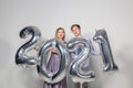 Party, people and new year holidays concept - woman and man celebrating new years eve 2021 Royalty Free Stock Photo