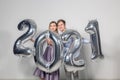 Party, people and new year holidays concept - woman and man celebrating new years eve 2021 Royalty Free Stock Photo