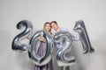 Party, people and new year holidays concept - woman and man celebrating new years eve 2021 Royalty Free Stock Photo