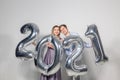 Party, people and new year holidays concept - woman and man celebrating new years eve 2021 Royalty Free Stock Photo