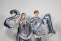 Party, people and new year holidays concept - woman and man celebrating new years eve 2021 Royalty Free Stock Photo