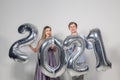 Party, people and new year holidays concept - woman and man celebrating new years eve 2021 Royalty Free Stock Photo