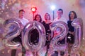 Party, people and new year holidays concept - women and men celebrating new years eve 2021