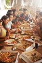 Party, pizza and group of friends at table eating together, having fun and bonding. Food, communication and people Royalty Free Stock Photo