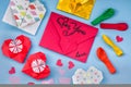 Party set of colorful balloons, origami paper hearts, envelopes onblue background. valentine day set Royalty Free Stock Photo