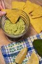 Party Snack - Mexican Nachos Chips dip Guacamole. Fresh healthy vegetarian dish of raw vegetables close-up Royalty Free Stock Photo