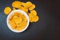 Potato chips and snacks on black slate table, top view Royalty Free Stock Photo