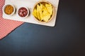 Potato chips and snacks on black slate table, top view Royalty Free Stock Photo