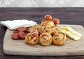 Sliced pepperoni, cheddar cheese and pepperoni pinwheels decorated with footballs.