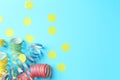 Party streamers and confetti on light blue background, flat lay. Space for text Royalty Free Stock Photo