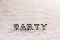 Party word on white sand