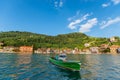 A passenger boat on the Oyarzun estuary with the mountain and the houses of Pasai Donibane in the background Royalty Free Stock Photo