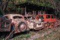 Pasanauri, Georgia - 06.10.2018: Old rusted out scrap retro cars that has been abandoned in forest woods