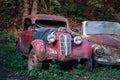 Pasanauri, Georgia - 06.10.2018: Old rusted out scrap retro cars that has been abandoned in forest woods