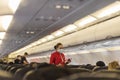 Pasay, Metro Manila, Philippines - A flight attendant inspects passenger seating inside the economy class cabin of an