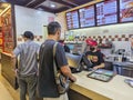 Pasay, Metro Manila, Philippines - A man orders a burger for dine-in at a Wendy\'s