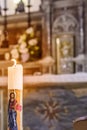 Paschal candle illuminates the altar and tabernacle of the heart of Jesus