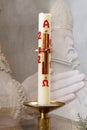 Paschal candle with religious background.