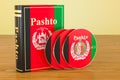 Pashto book with flag of Afghanistan and CD discs on the wooden