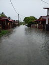 Pasir Puteh, Kelantan - February 27, 2022 : An road under water. Flooded cars on streets of the village. flood disaster