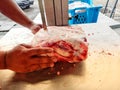 pasirmas,kelantan- Close-up of butcher cutting meat with meat cutting machine Royalty Free Stock Photo