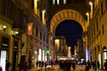 Passage, illuminated in the winter evening, which leads from via degli Strozzi to piazza della Repubblica in Florence.