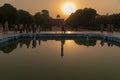 Sunrise reflected in the water in a Taj Mahal pool