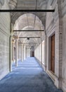 Passage in Nuruosmaniye Mosque, with columns, arches and floor covered with blue carpet lighted by side windows, Istanbul, Turkey Royalty Free Stock Photo