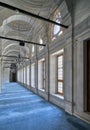 Passage in Nuruosmaniye Mosque with columns, arches and floor covered with blue carpet lighted by side windows, Istanbul, Turkey Royalty Free Stock Photo