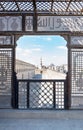 Passage surrounding the Mosque of Ibn Tulun framed by interleaved wooden perforated wall Mashrabiya