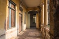 Passage with tiled floor and boarded-up windows along columns on the second floor of the Mansion or Villa Bodega Royalty Free Stock Photo