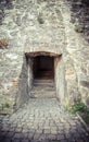 Passage between two parts of the ancient castle with an old stone staircase. Stone arch and steps in the castle. Stone corridor Royalty Free Stock Photo