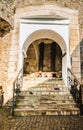 Passage between two parts of the ancient castle with an old stone staircase. Stone arch and steps in the castle. Stone corridor Royalty Free Stock Photo
