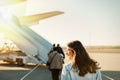 Passager walking from the airport terminal to the airplane for departure. Royalty Free Stock Photo