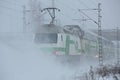 A passanger train going trough the snowstorm