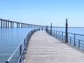 Walking the footpath Passeio do Tejo along Tagus river in Lisbon at the Expo park - Vasco da Gama bridge Royalty Free Stock Photo