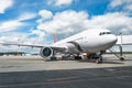 Passenger aircraft with boarding stairs, waiting for boarding passengers and baggage before the flight, summer airport trip Royalty Free Stock Photo