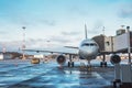 Passenger aircraft with boarding stairs, waiting for boarding passengers and baggage before the flight airport trip Royalty Free Stock Photo