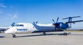 Passenger aircraft Bombardier Q400 of Aurora Airlines on airfield. Turboprop engine. Aviation and transportation