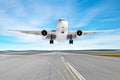 Passenger aircraft with a cast shadow on the asphalt landing on a runway airport, motion blur.